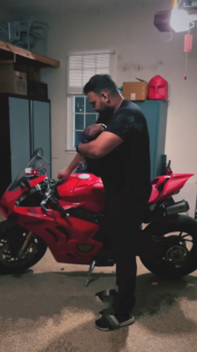 An irresponsible Ducati Panigale owner brings his infant to listen to the exhaust note in a closed garage